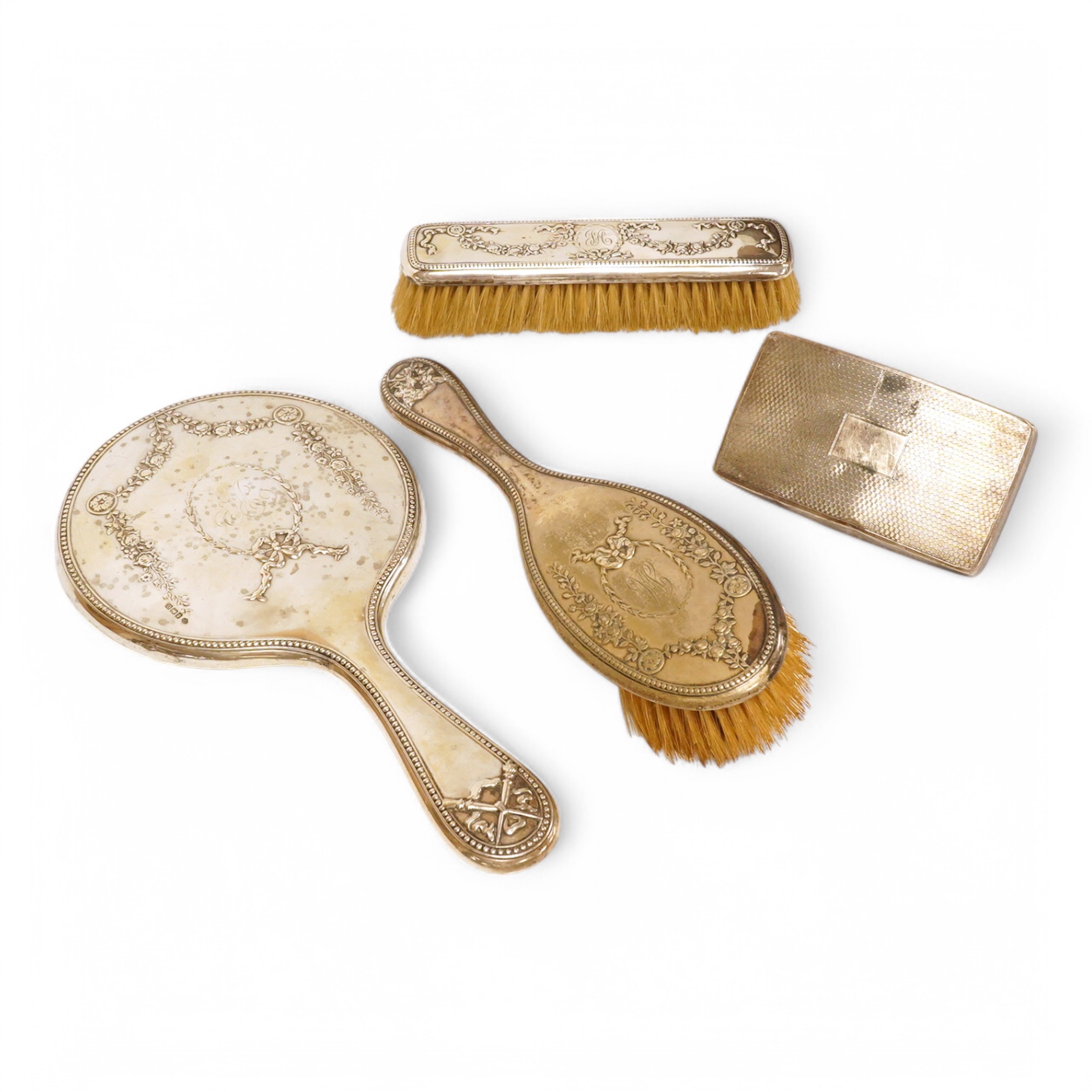 A George V three piece silver mounted three piece mirror and brush set by William Hutton & Sons Ltd and one other silver mounted hair brush. Condition - poor